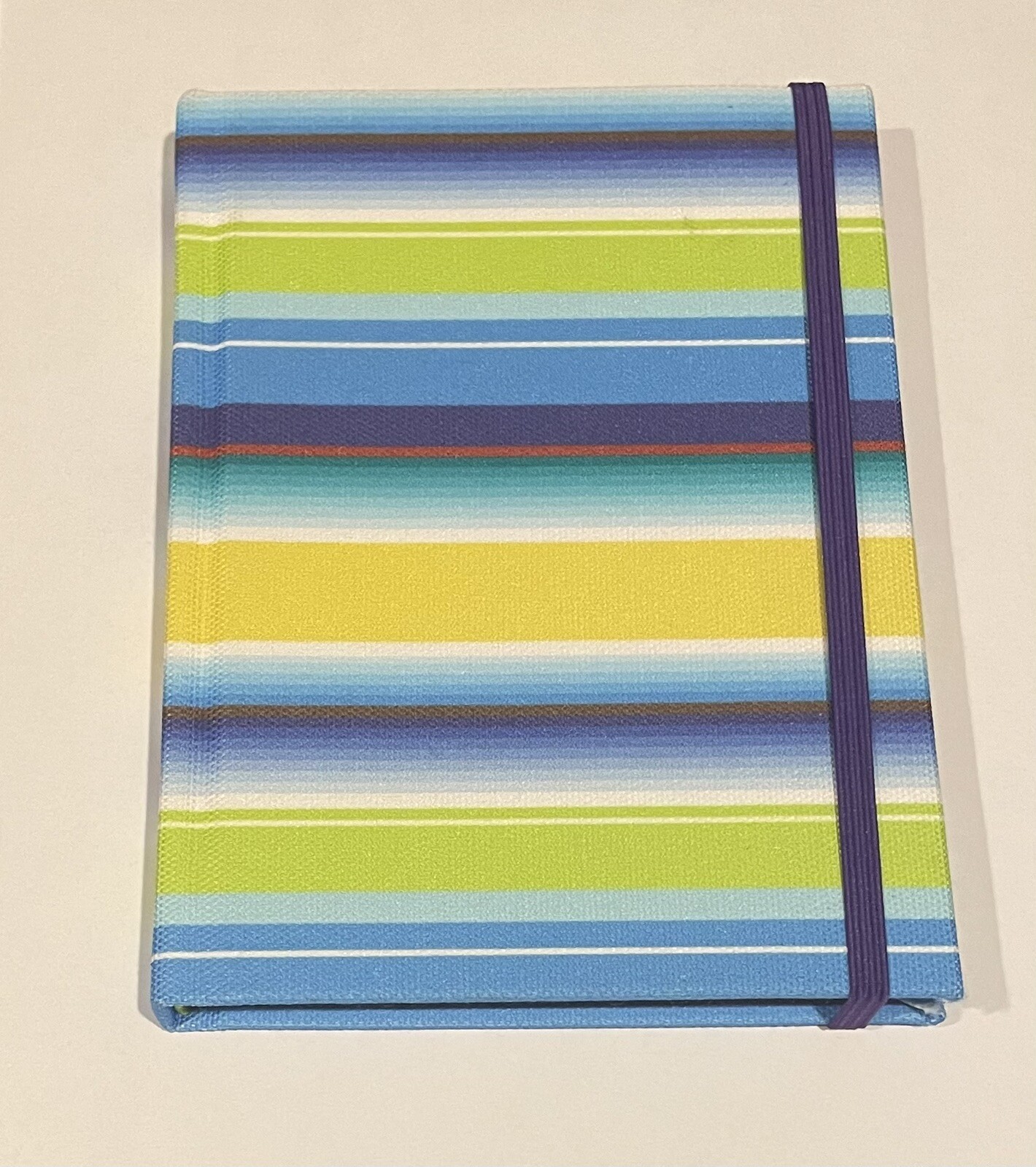 small colorful journal with elastic band